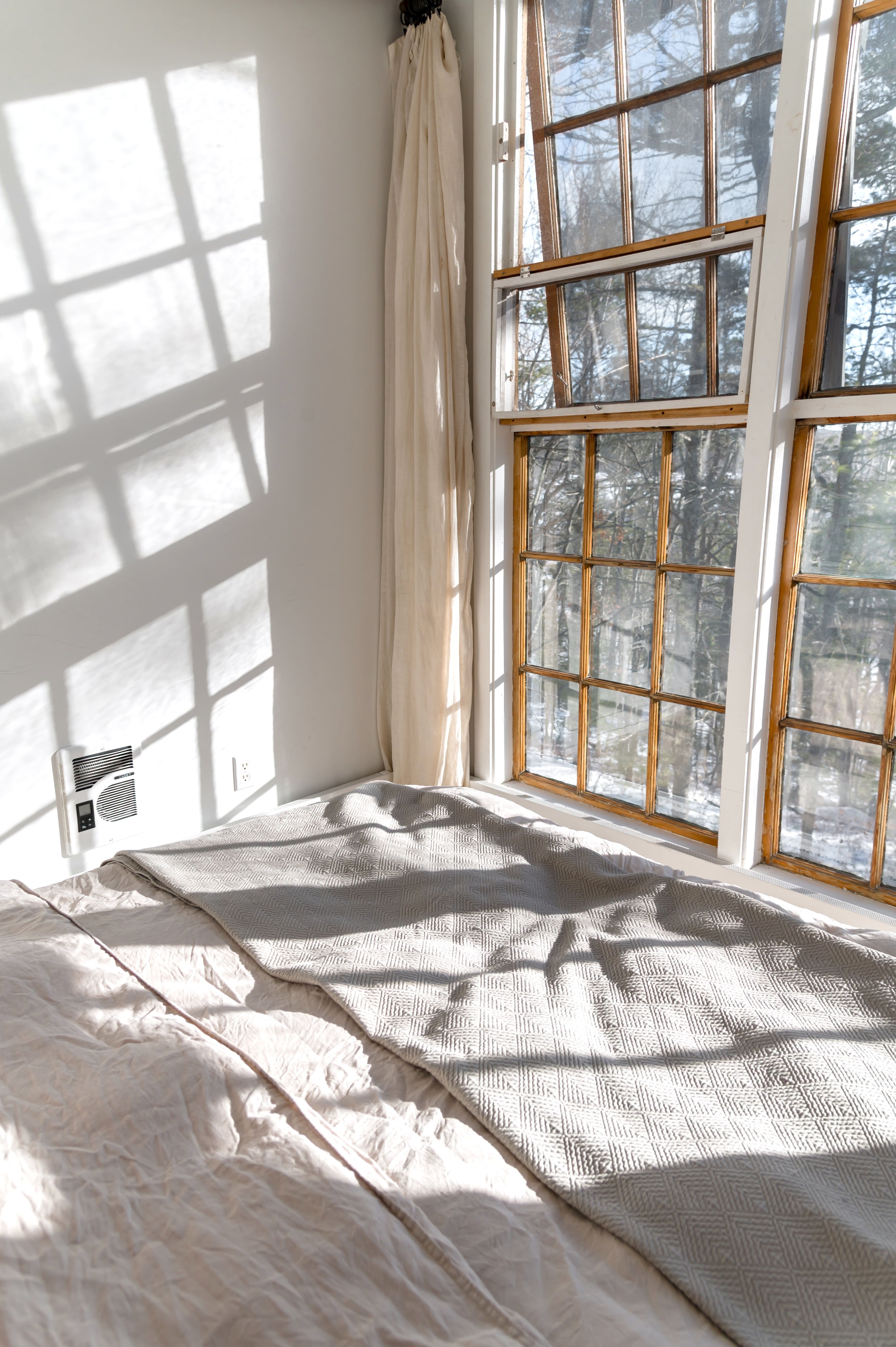 Bright bedroom inspo ideas with sunlight streaming through large windows