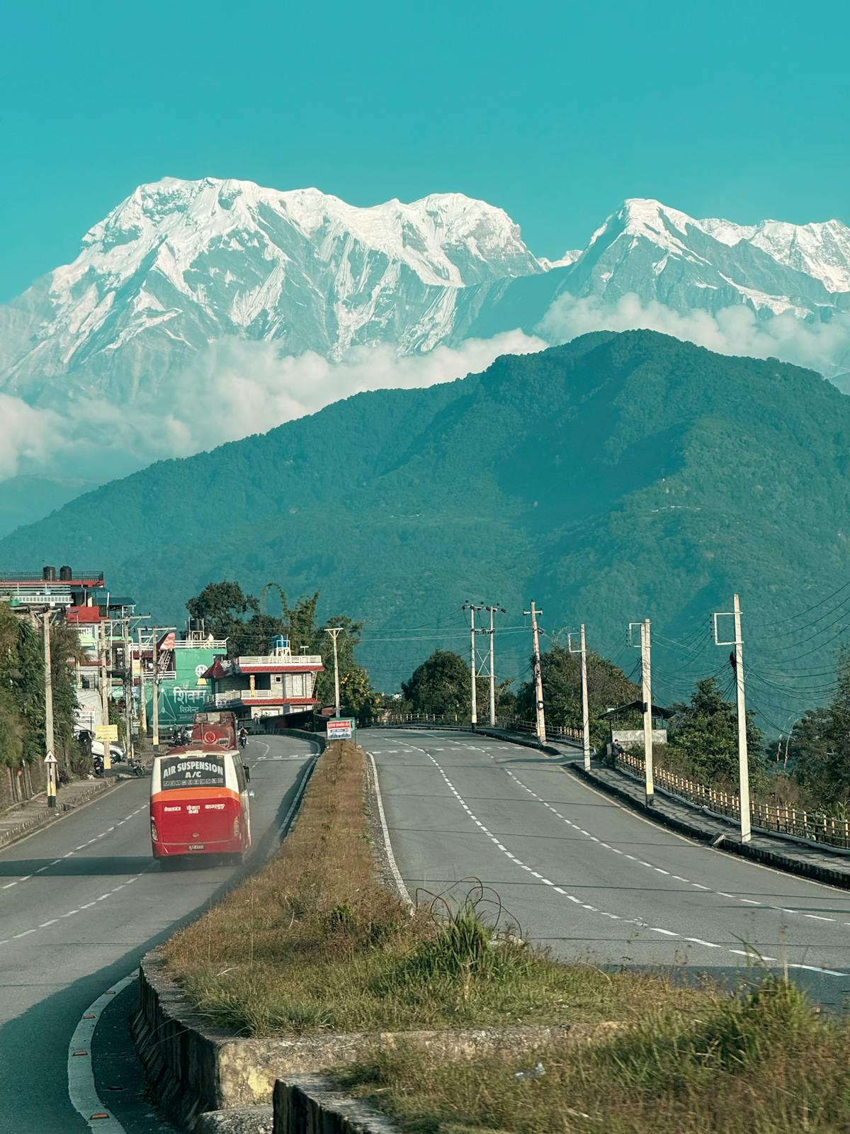 Scenic mountain road winding through the Himalayas in Nepal with dramatic peaks in the distance