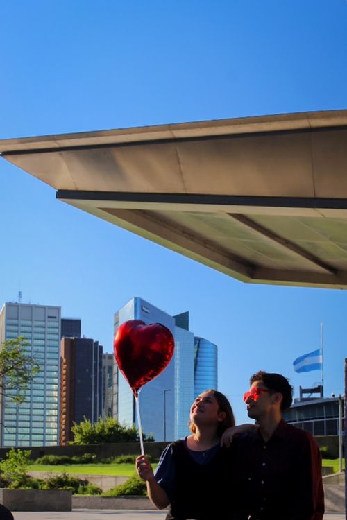 Free Couple enjoying a romantic moment with heart balloon in Buenos Aires. Stock Photo
