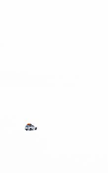 Minimalist image of a solitary car on the vast Uyuni Salt Flats in Bolivia.