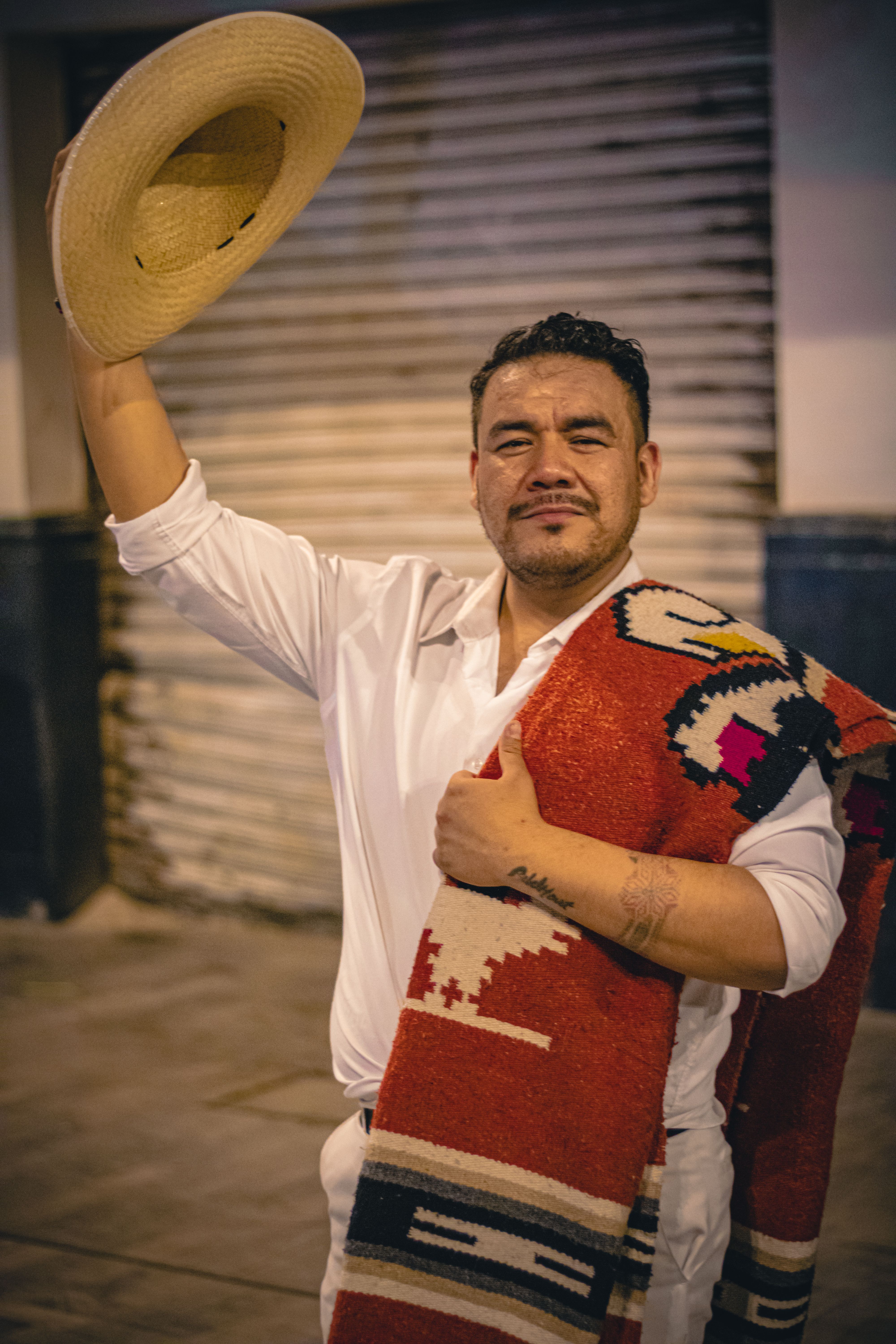 Mexican dancer in traditional attire posing on a street, Mexico City.