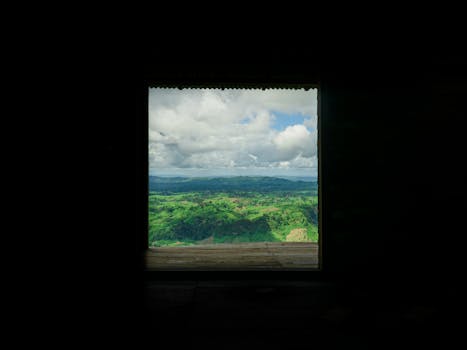 Stunning view of Bangladesh's green hills through a modern window frame.