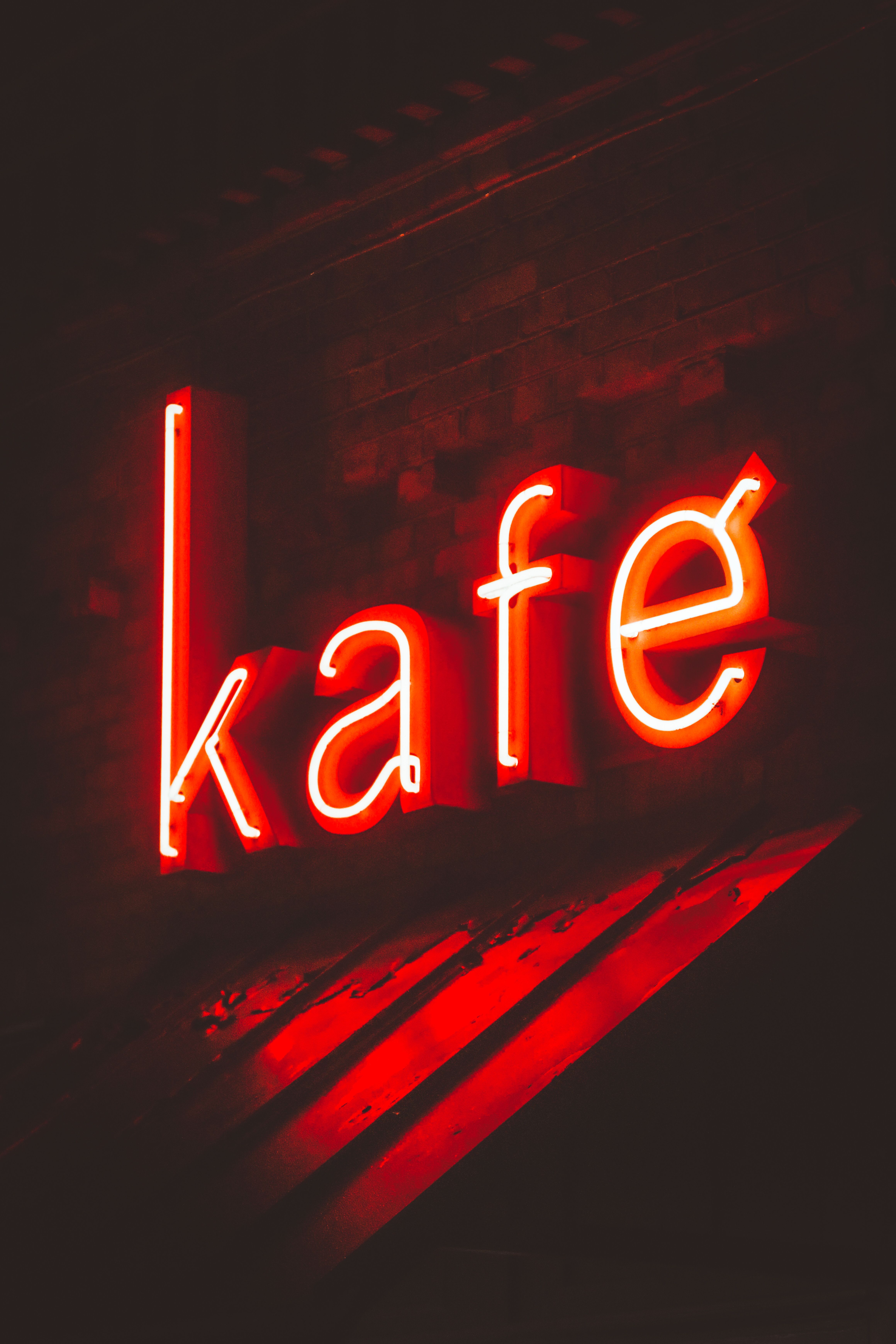 Neon Red Cafe Sign Illuminates Night Scene · Free Stock Photo