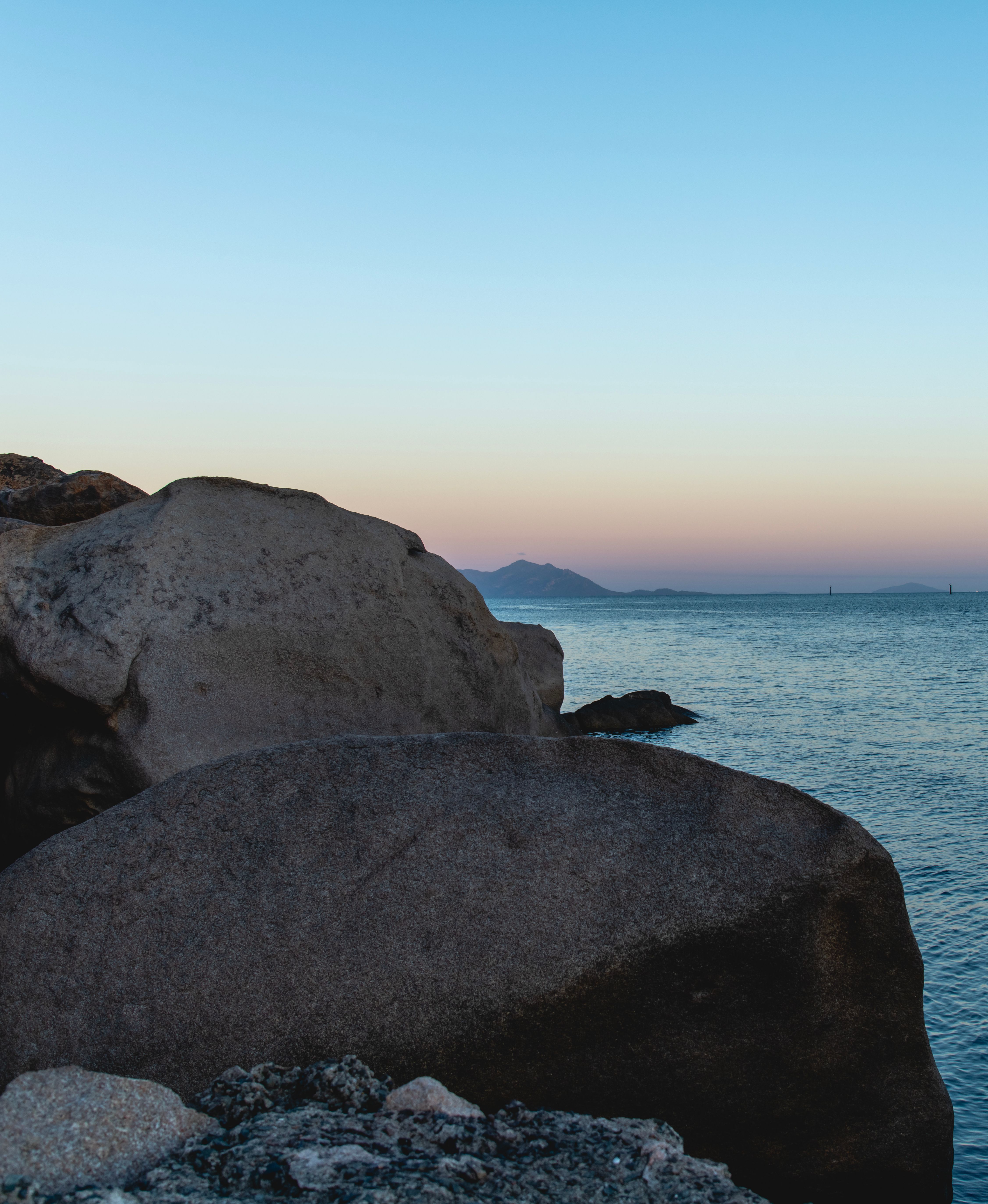 Serene Coastal Rocks at Twilight Sunset · Free Stock Photo