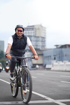 A cyclist cruising through city streets in West Java, Indonesia, showcasing urban cycling culture.