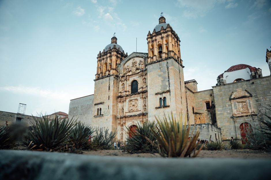 Santo Domingo de Guzmán church with agave plants in the foreground, Oaxaca, Mexico