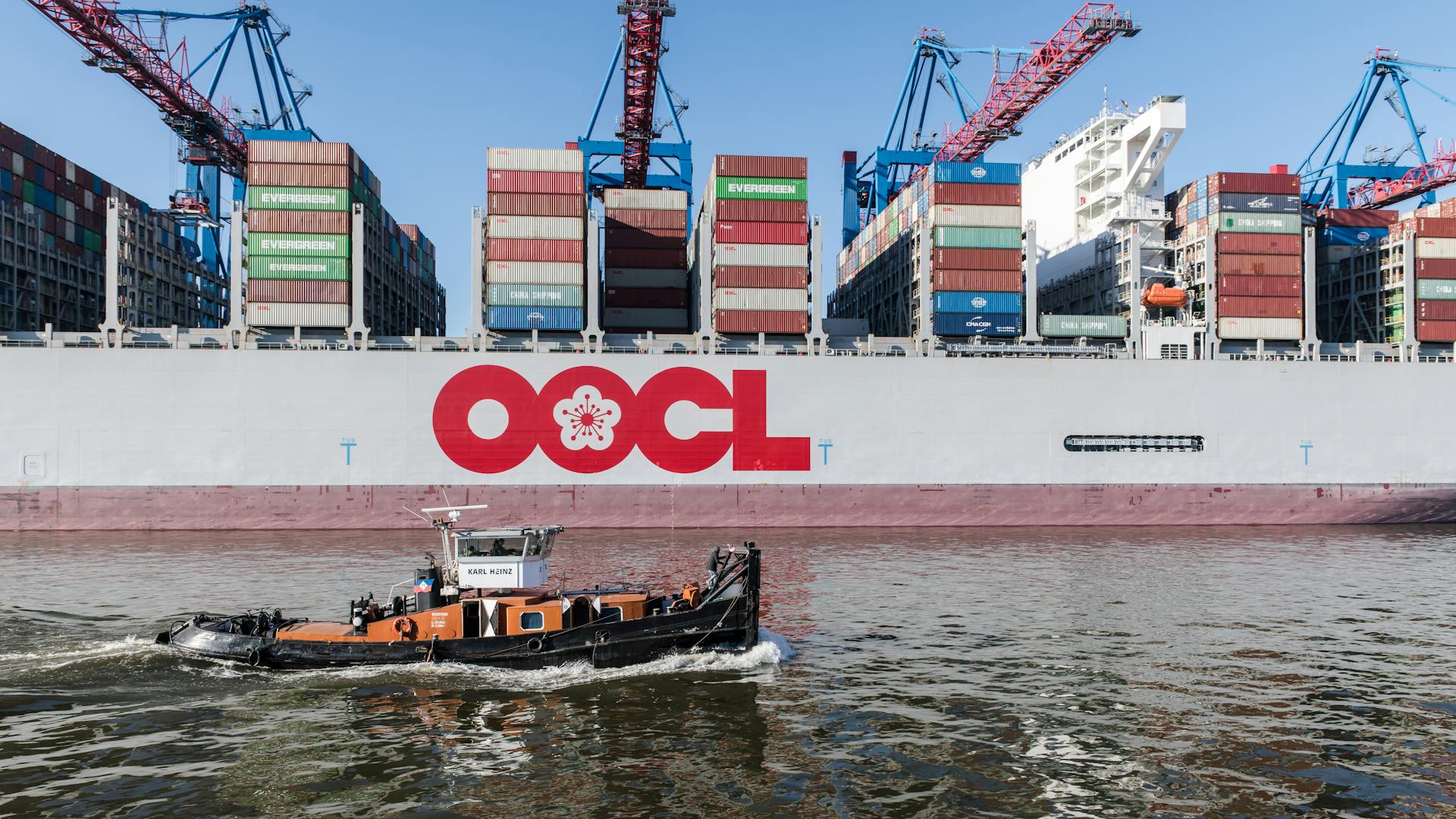 A cargo ship with OOCL logo loaded with containers at Hamburg Port.