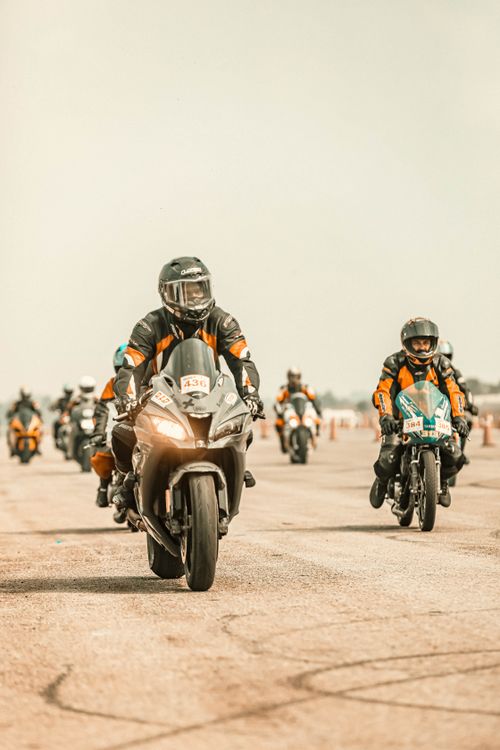 Free Exciting motorcycle race showcasing bikers in action on the open road in Bengaluru, India. Stock Photo