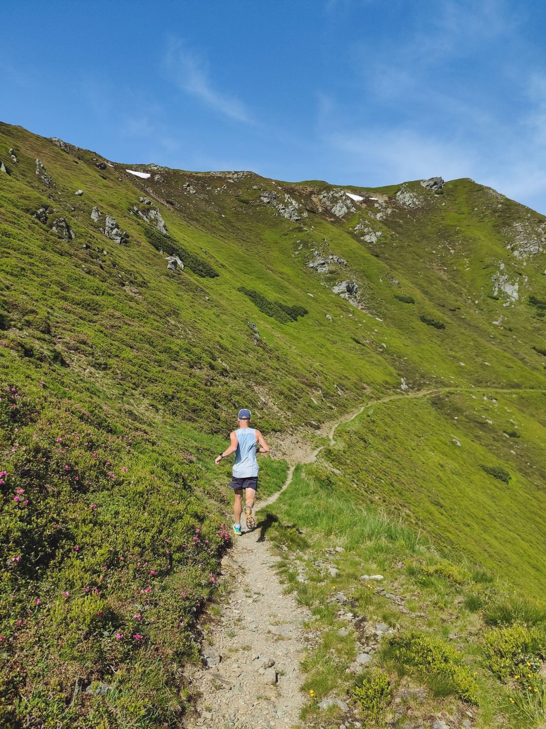 Runner on mountain trail at sunrise