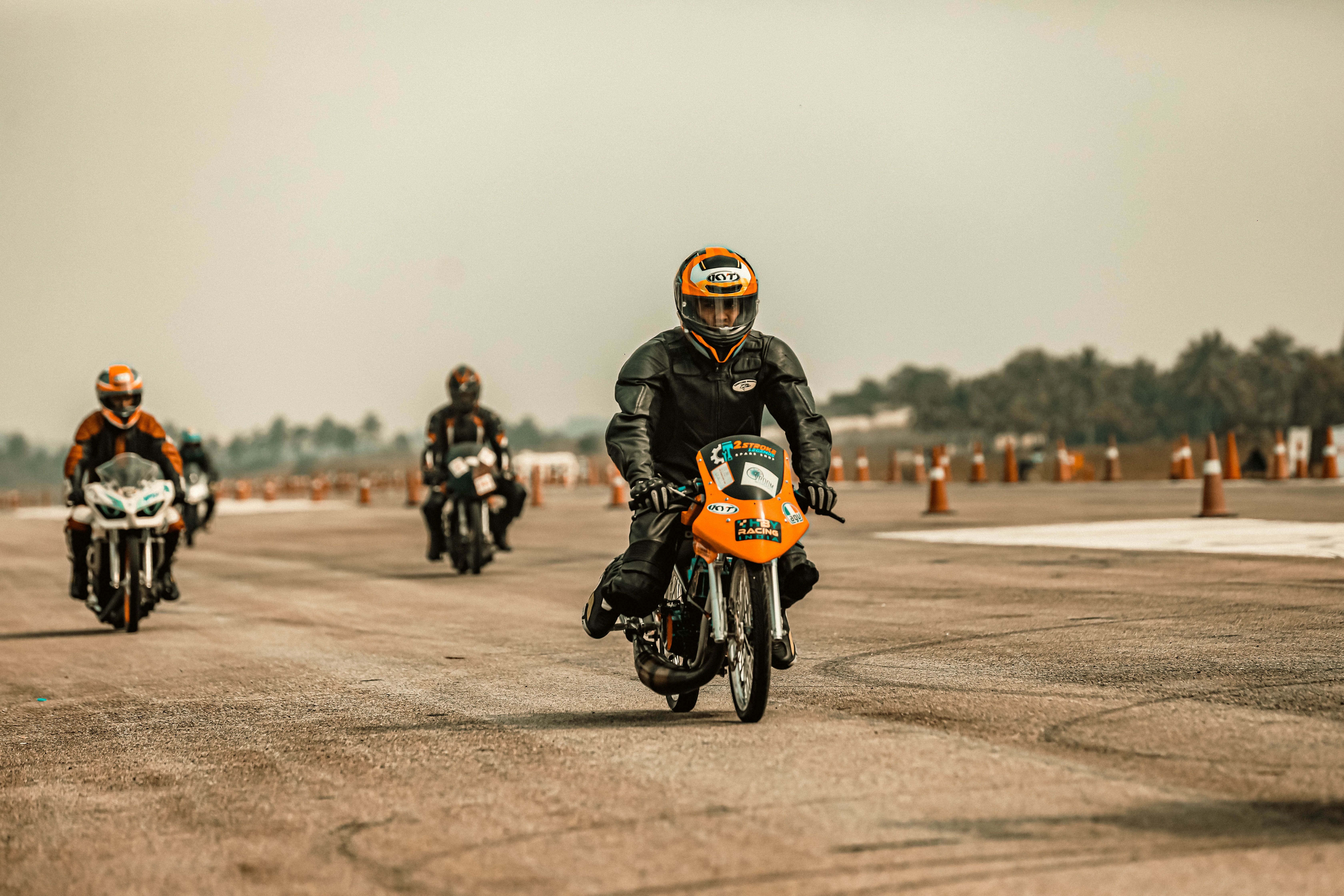 Motorcyclists in a thrilling open road race wearing protective gear.