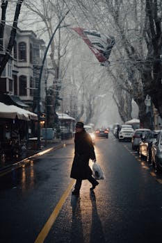 A man crosses a snowy street in İstanbul's Kuzguncuk during winter with an atmospheric and cinematic feel.