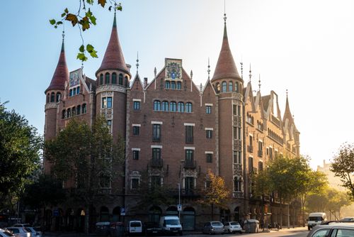 Free Stunning historic brick building in Barcelona, capturing gothic architecture under a clear blue sky. Stock Photo