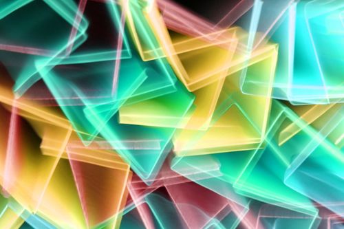 Free Vibrant abstract art featuring colorful geometric light patterns in an energetic composition. Stock Photo