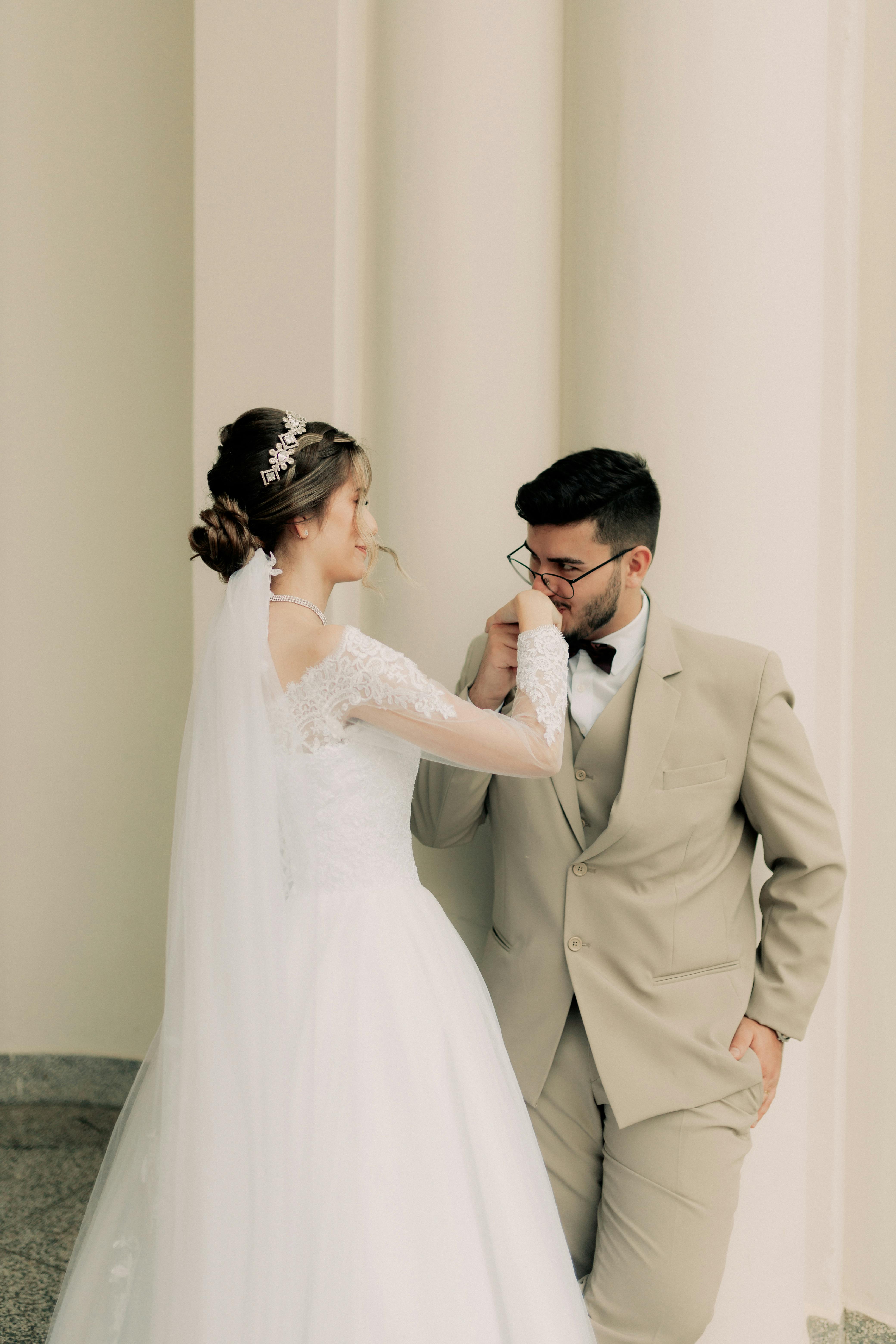 A romantic moment between a bride and groom captured indoors, exuding elegance.
