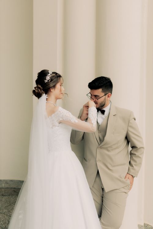 Free A romantic moment between a bride and groom captured indoors, exuding elegance. Stock Photo