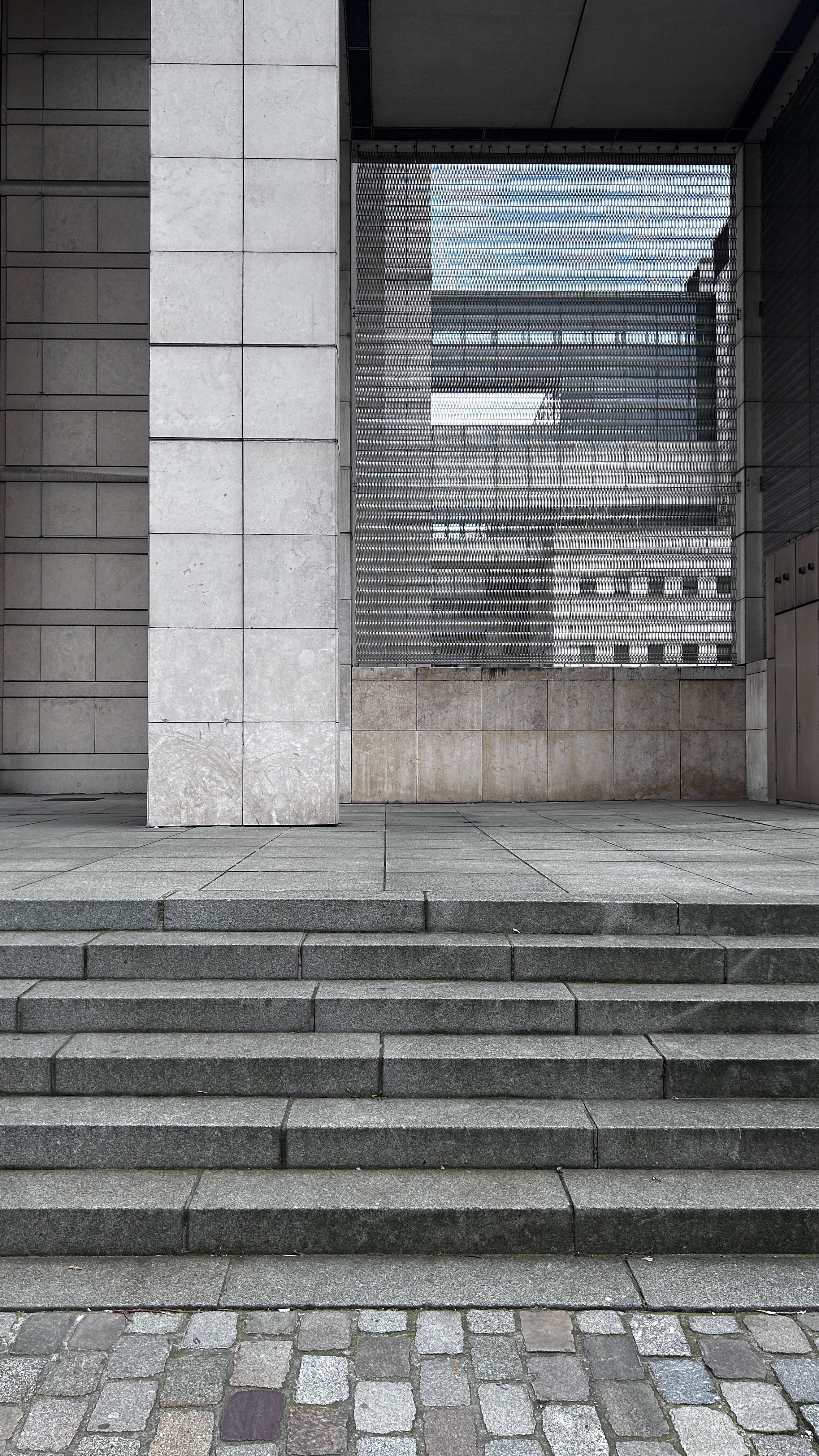 A modern architectural facade in Paris showcasing sleek urban design and reflections.