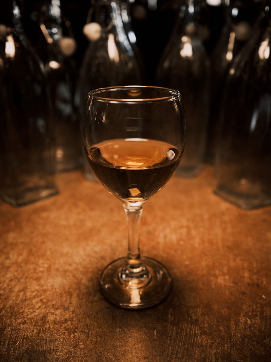 A glass of deep amber-gold vin jaune
