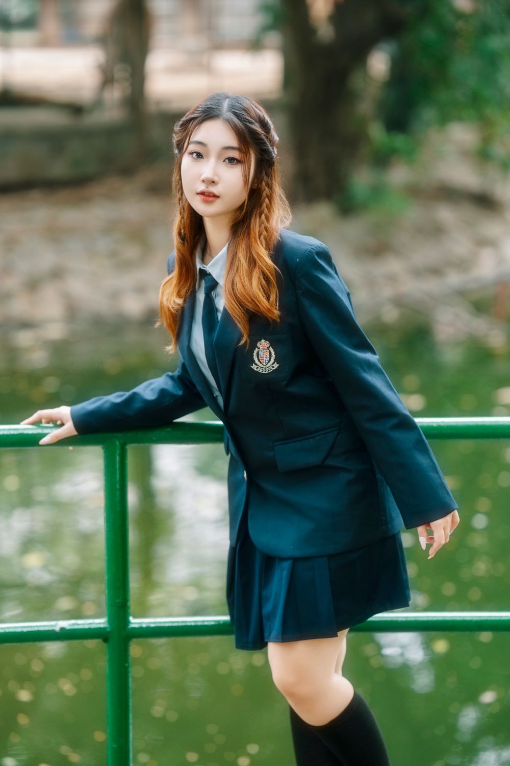 Young Woman in School Uniform by Pond · Free Stock Photo