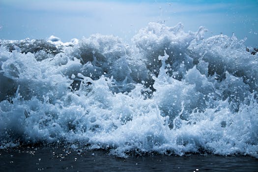 Powerful waves crashing ashore at Barra Vieja, Mexico in vibrant blue tones.