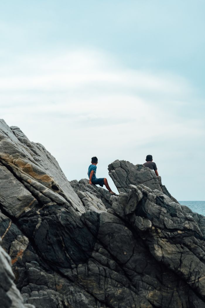 People enjoying the rocky Puerto Escondido coastline