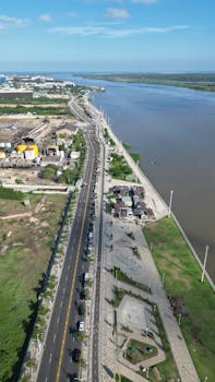 Drone shot capturing the Magdalena River and urban areas in Barranquilla, Colombia.