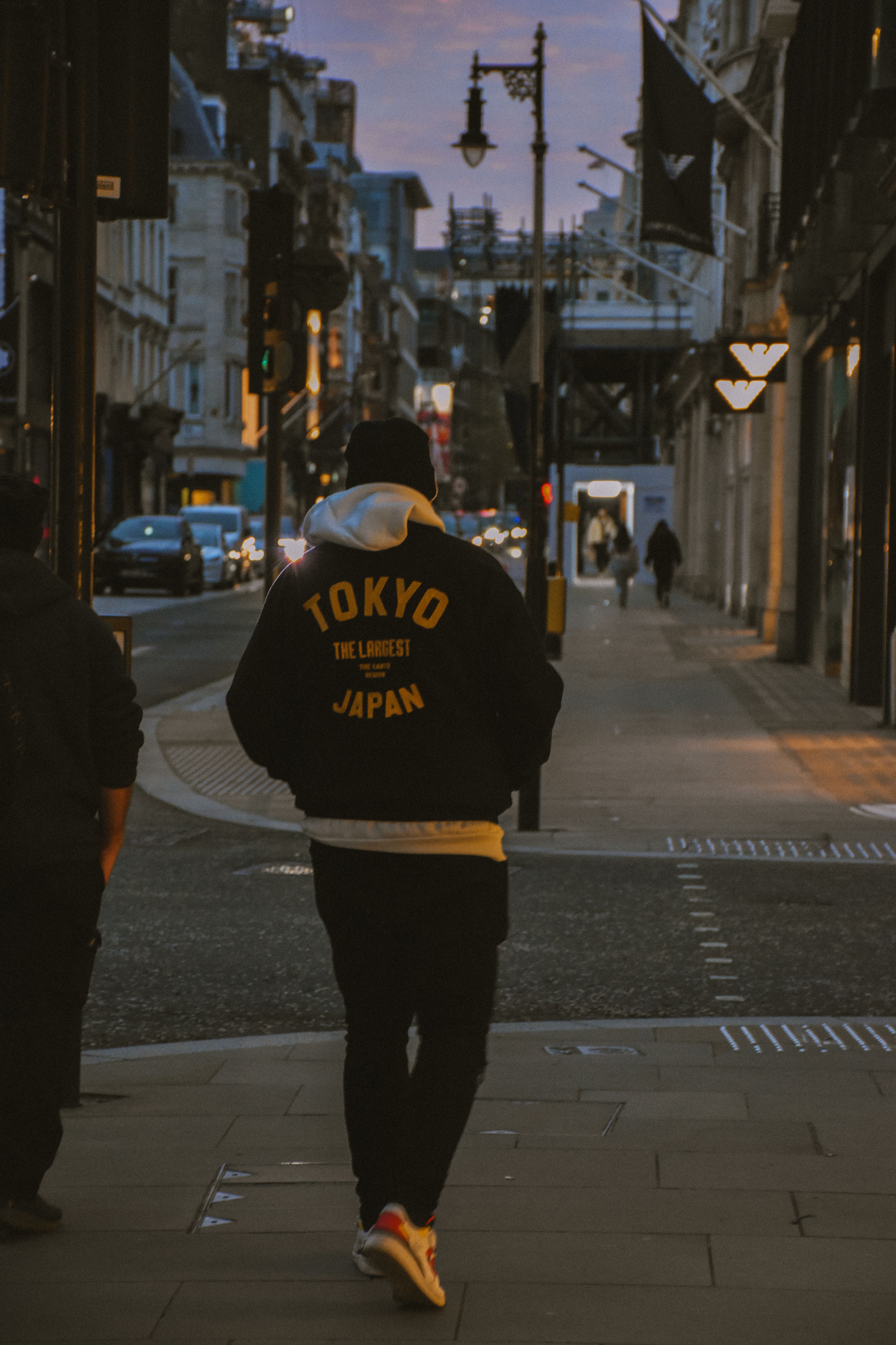 Man walking in moody London street during evening.