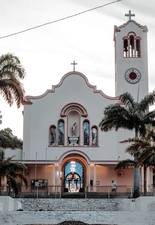 Free Charming church facade with palm trees in Araruama, Rio de Janeiro, Brazil. Stock Photo