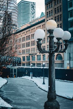 Snowy street scene featuring vintage lamppost and historic architecture in Toronto, Canada.