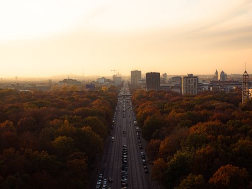 Free Scenic aerial view of Berlin at sunset with vibrant autumn foliage and city skyline. Stock Photo