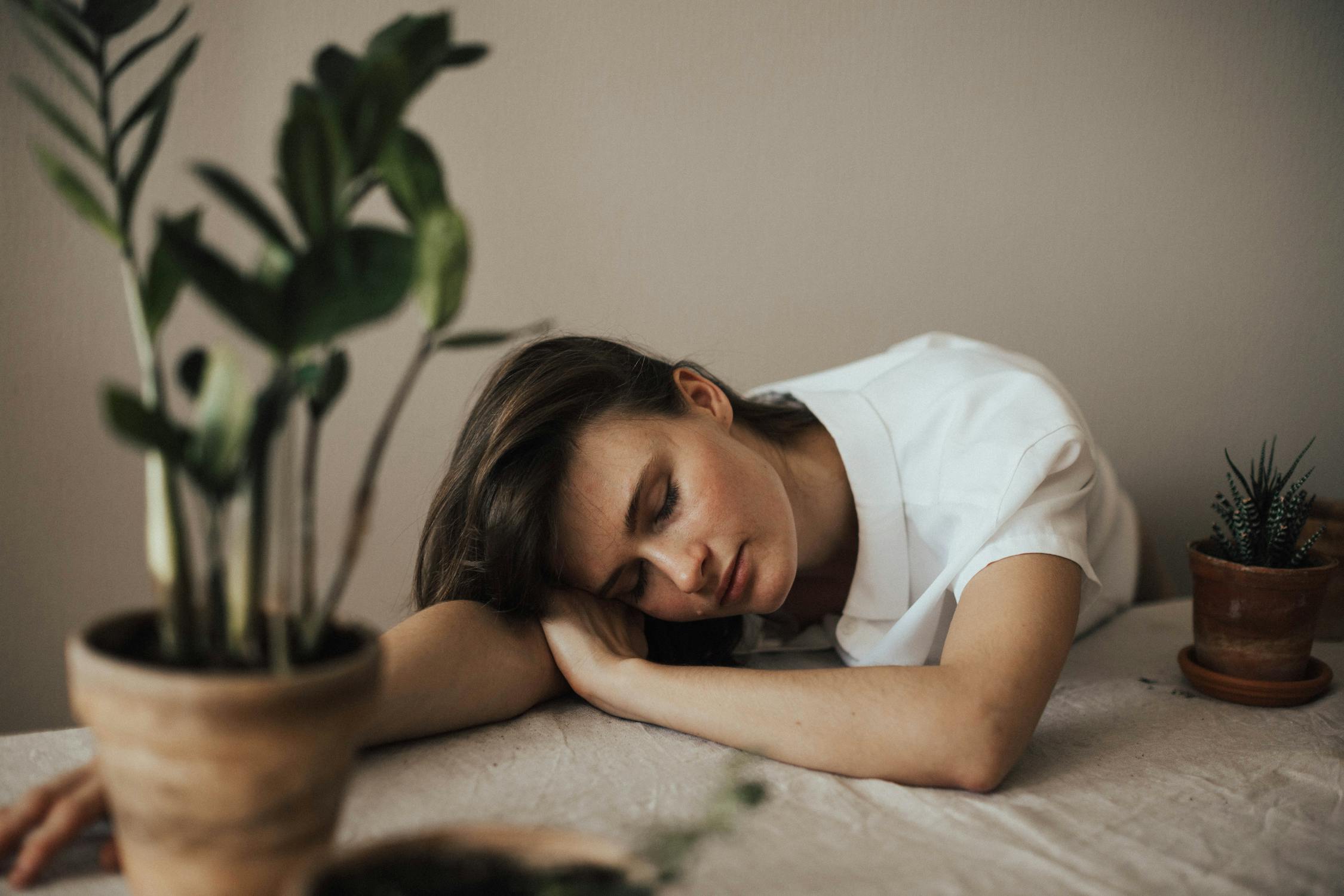 Image of a woman wearing collared top laying on table