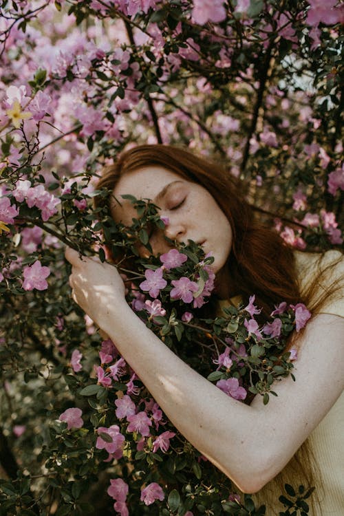 Free Woman Hugging Flowering Tree Stock Photo