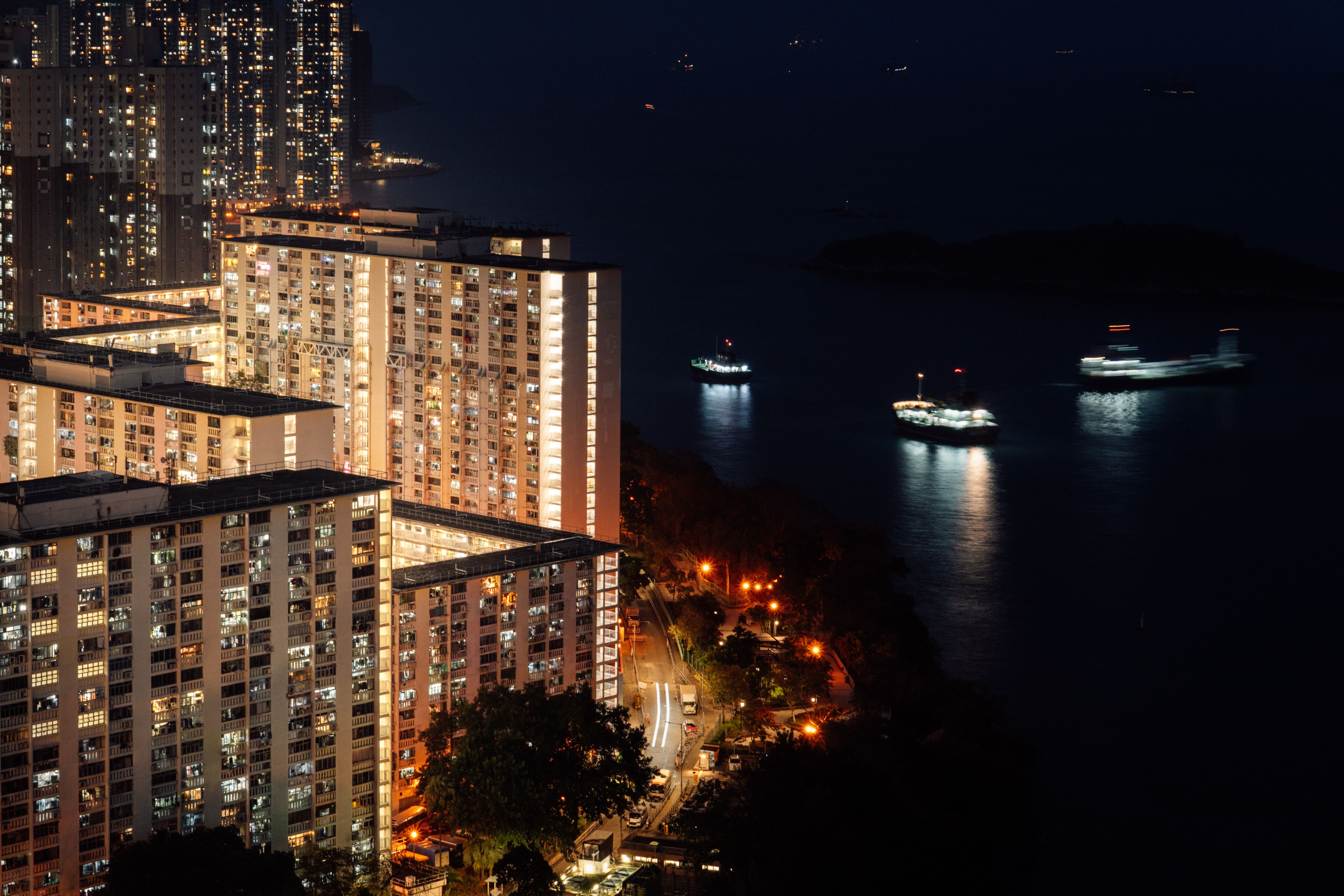 Nighttime Cityscape with Illuminated Buildings and Boats · Free Stock Photo