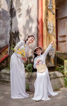 Mother and daughter in white ao dai at Hội An, Vietnam.
