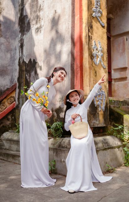 Mother and daughter in white ao dai at Hội An, Vietnam.