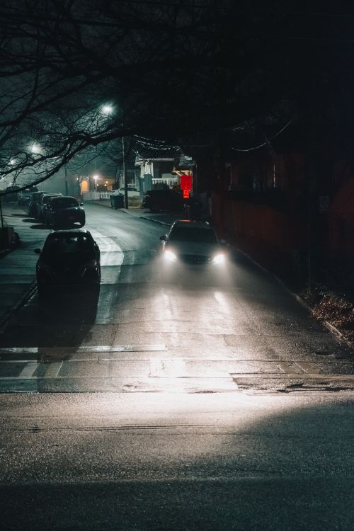 Free A car on a dimly lit street at night in Atlanta. Urban atmosphere. Stock Photo