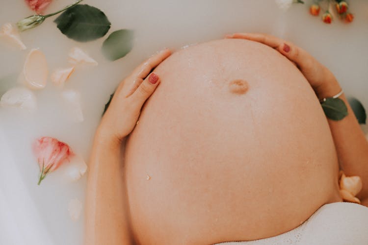 Pregnant Woman Sitting On Bathtub