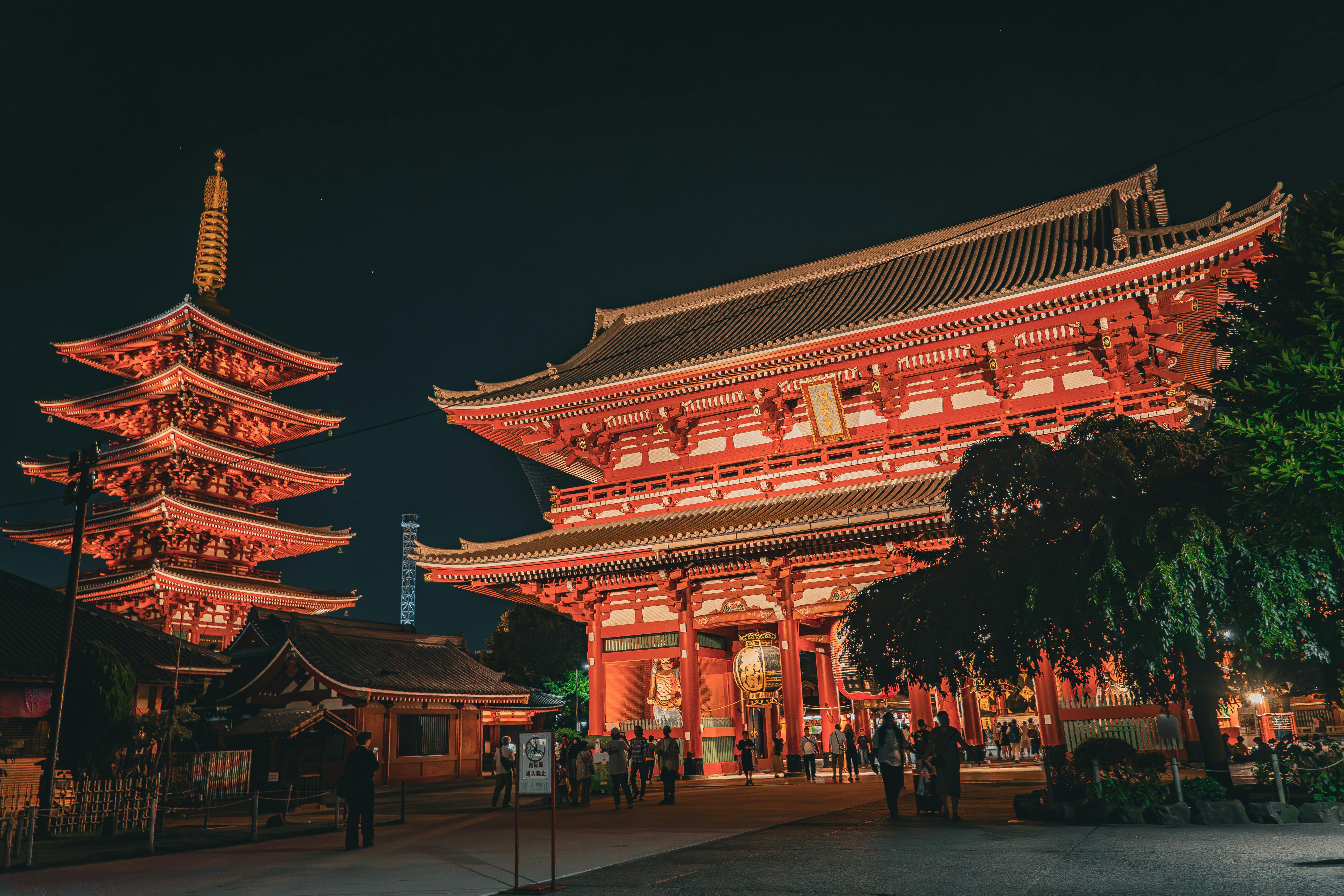 Illuminated Senso-ji Temple in Tokyo at night, showcasing traditional Japanese architecture.