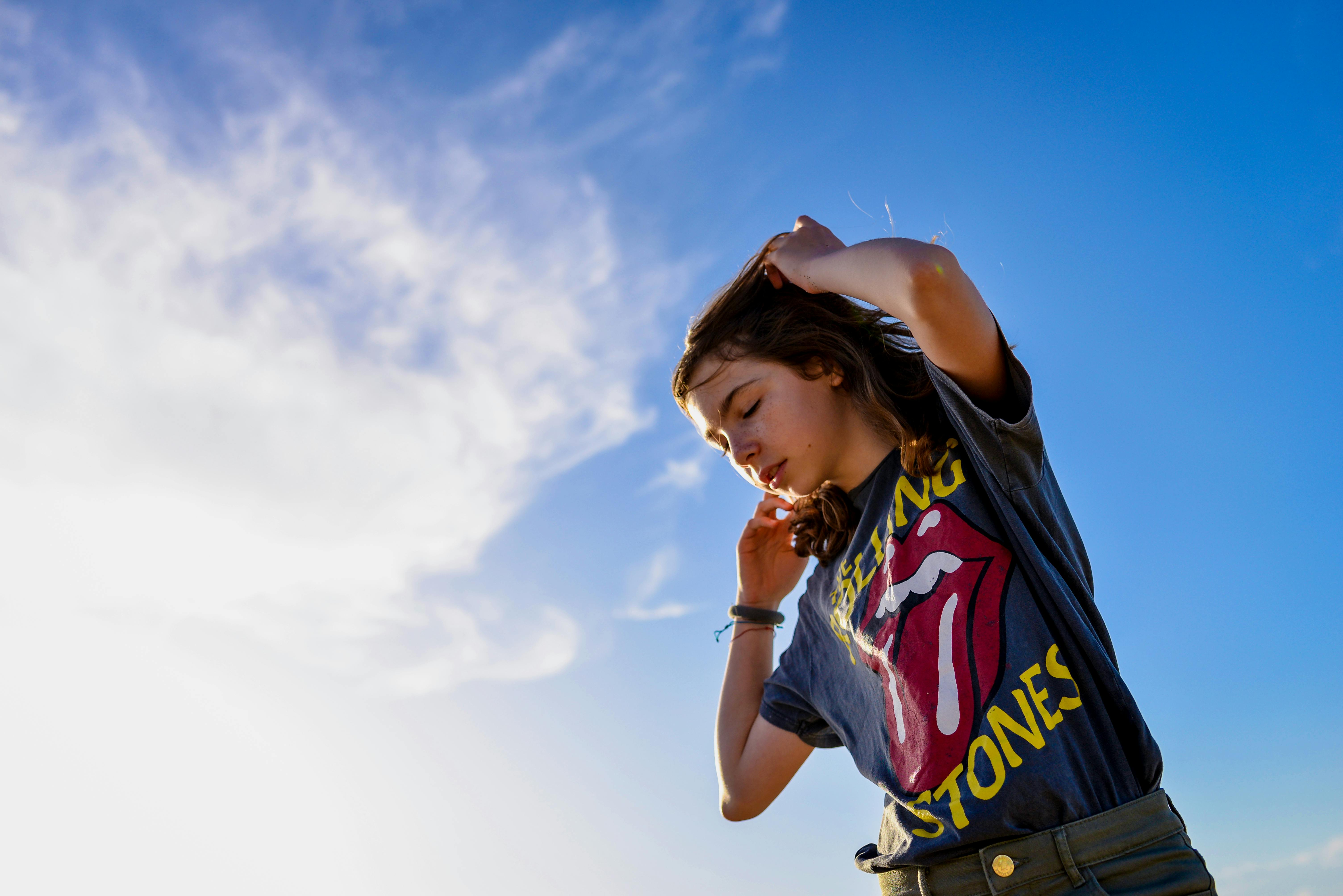 low angle photo of girl raising her both arms