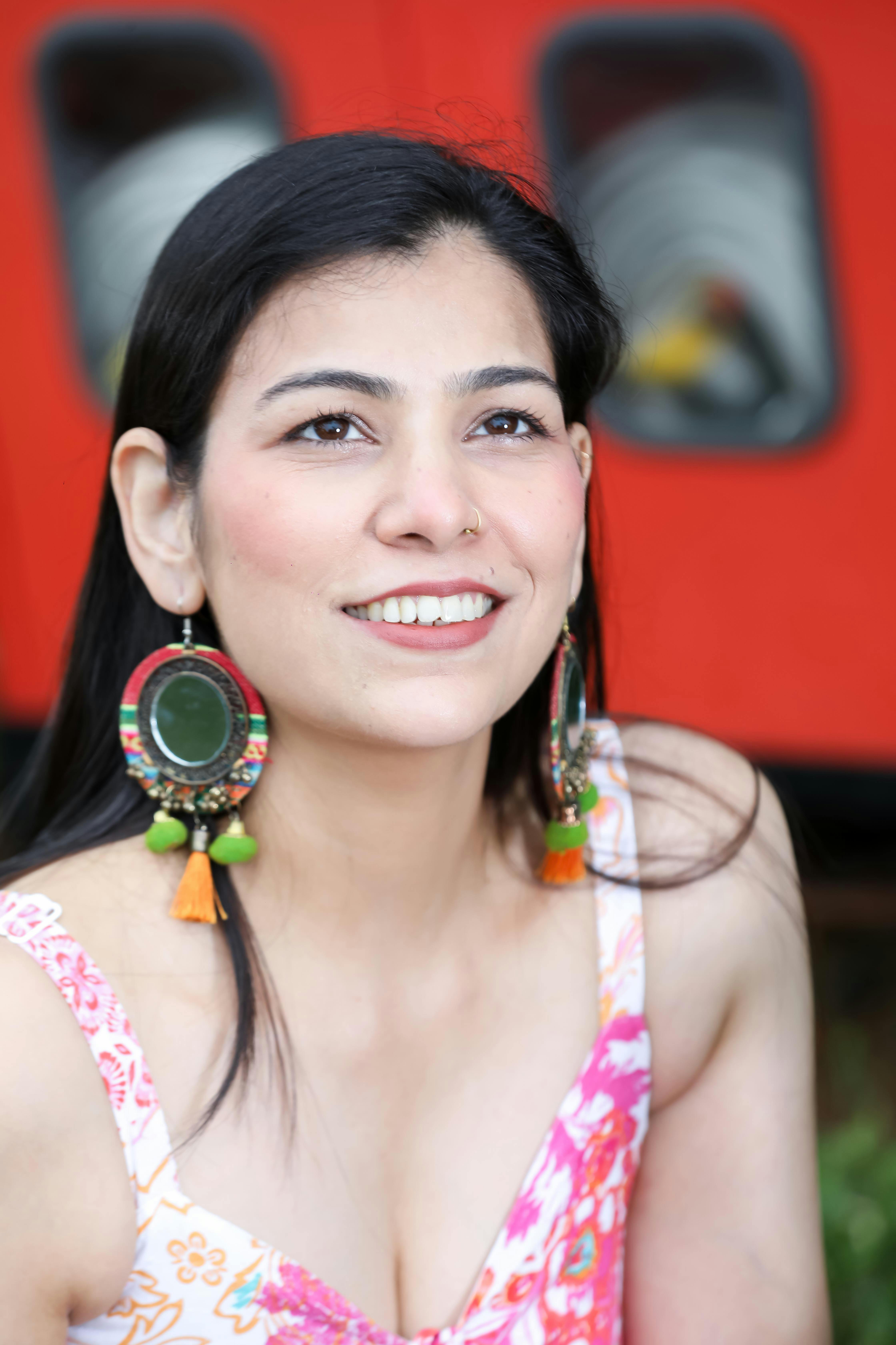 portrait of a smiling woman with colorful earrings