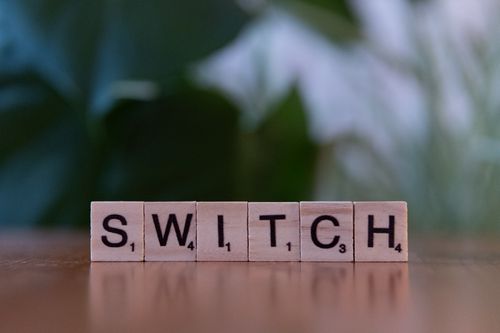 Free Close-up of wooden tiles spelling 'Switch', perfect for education and games themes. Stock Photo