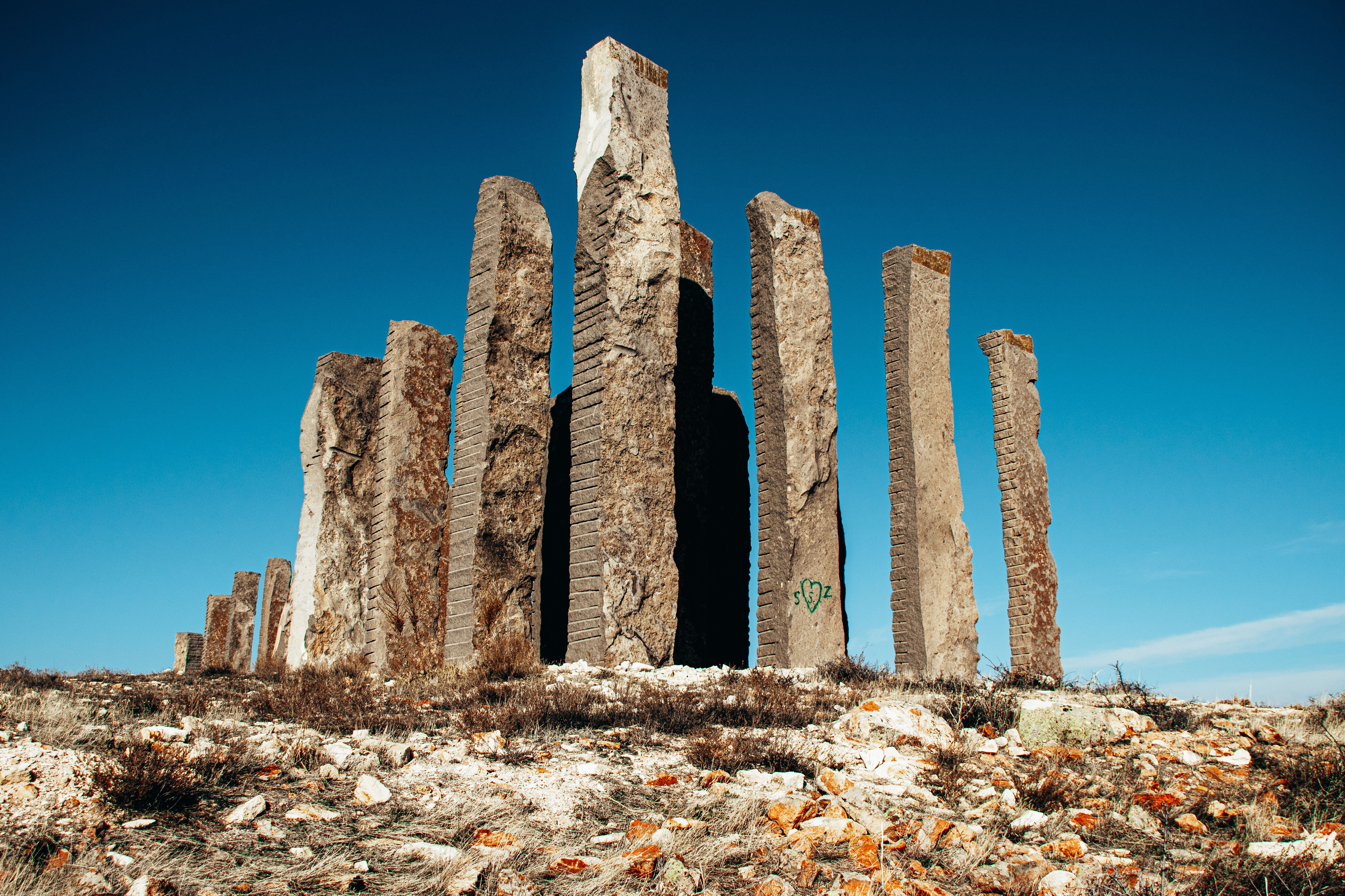 a single tall pillar standing in a field of scattered rubble, representing a cornerstone page vs. weak content