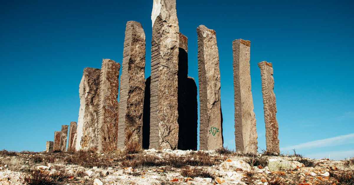 a single tall pillar standing in a field of scattered rubble, representing a cornerstone page vs. weak content