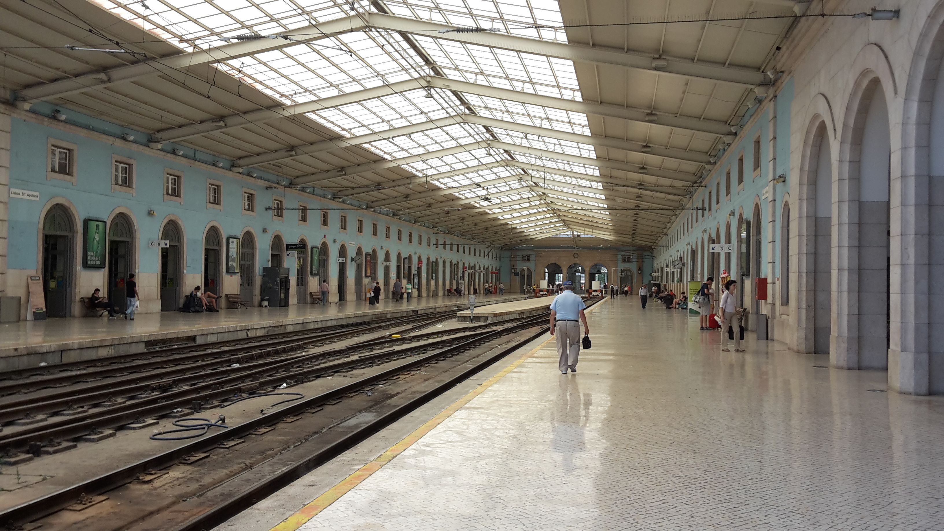 Hand holding a Viva Viagem card at a Lisbon metro station in Portugal