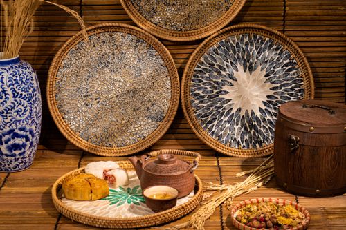 Free A traditional Asian tea setting with a rustic bamboo background and artistic woven trays. Stock Photo