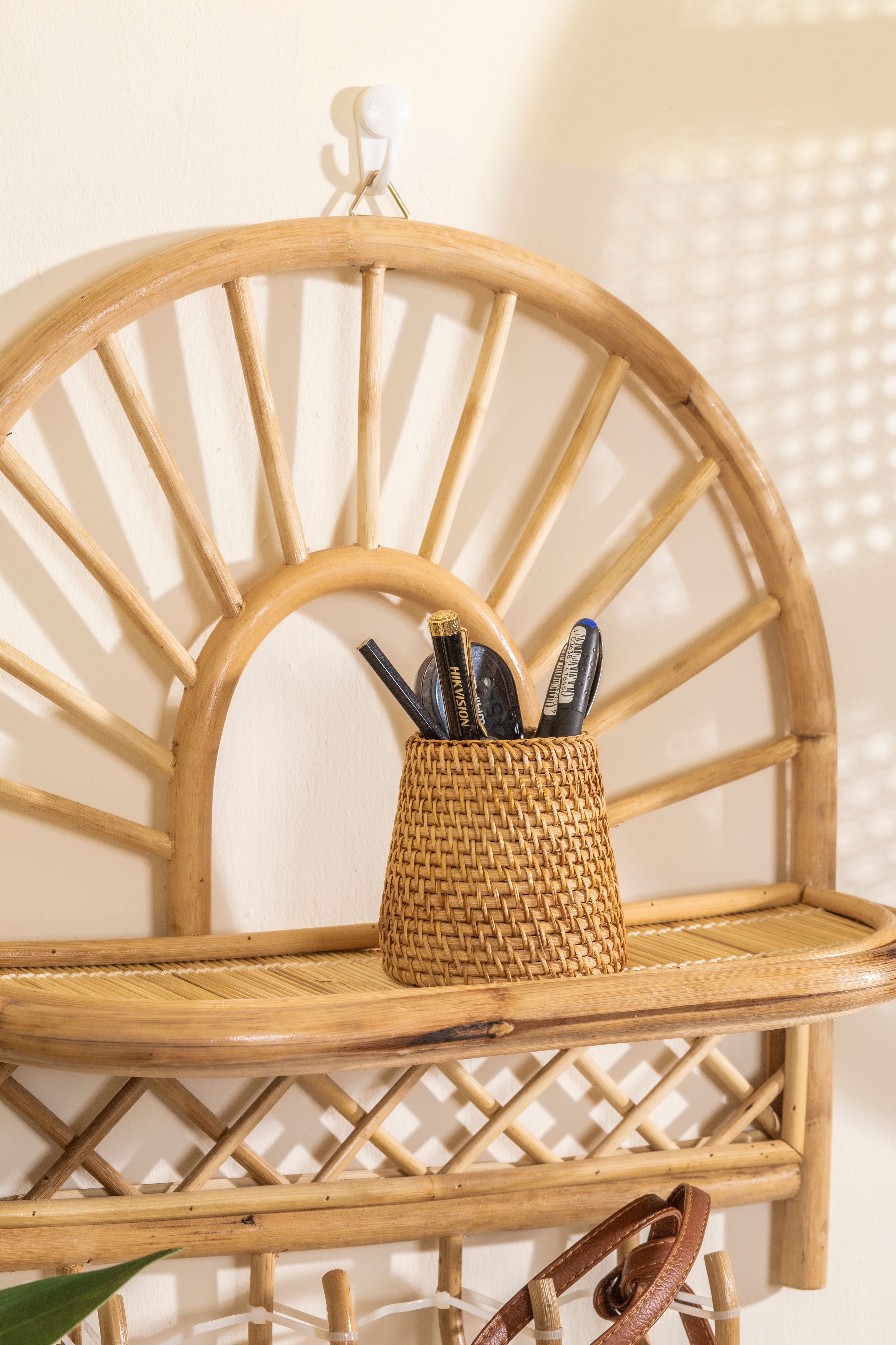 Woven rattan baskets used for storage on a boho coffee bar shelf next to coffee accessories