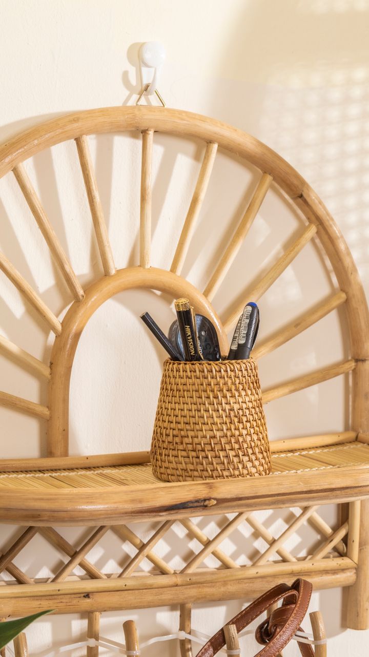 Woven rattan baskets used for storage on a boho coffee bar shelf next to coffee accessories