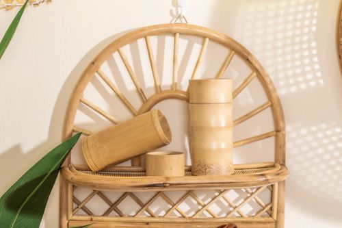 Free Elegant bamboo containers on a wicker shelf with vibrant natural light and shadows. Stock Photo