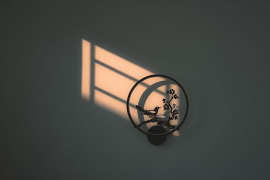 Artistic shadow of metal wall decor shaped like a bird at sunset in Ho Chi Minh City.