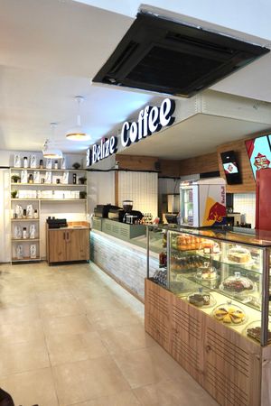 Warm cafe interior with wooden seating. Photo by Batuhan Kocabas on Pexels.