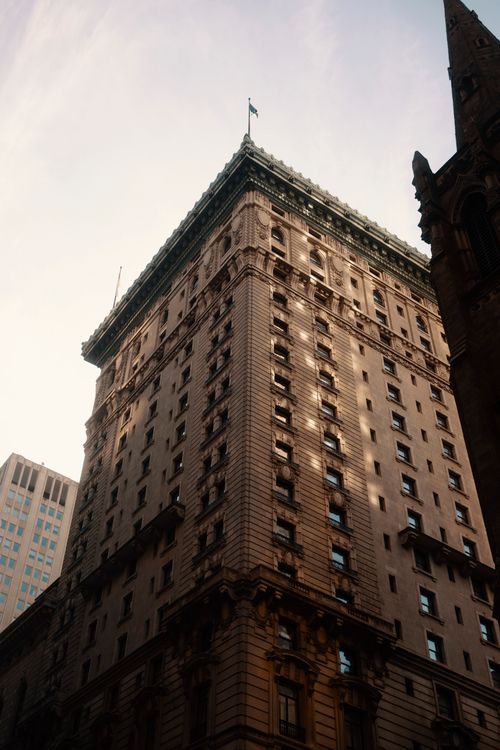 Free Stunning view of a historic skyscraper viewed from below in an urban cityscape setting. Stock Photo